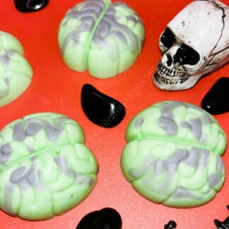 Green brain-shaped Halloween wax melts with grey detailing, perfect for spooky home fragrance. these handmade wax melts are ideal for Halloween décor, gifts, and seasonal scent collections